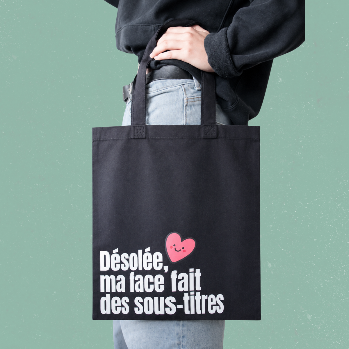Sac fourre-tout noir avec le message Desolee ma face fait des sous-titres, boutique Sans Filtre