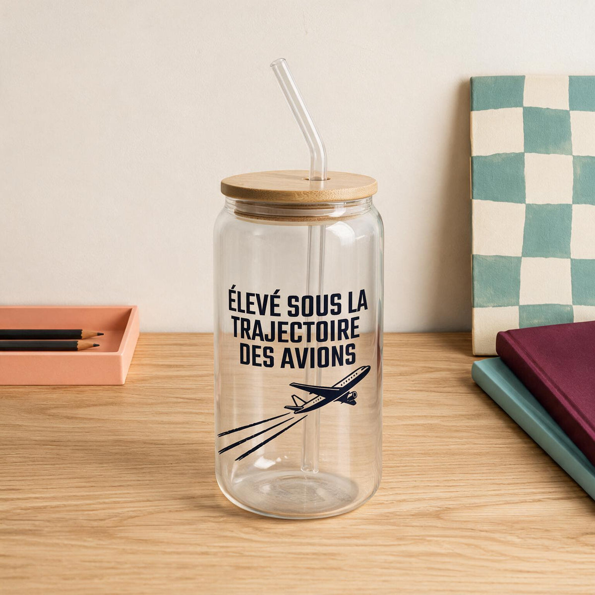 Verre en verre avec couvercle de bambou et paille, message Eleve sous la trajectoire des avions, boutique Sans Filtre